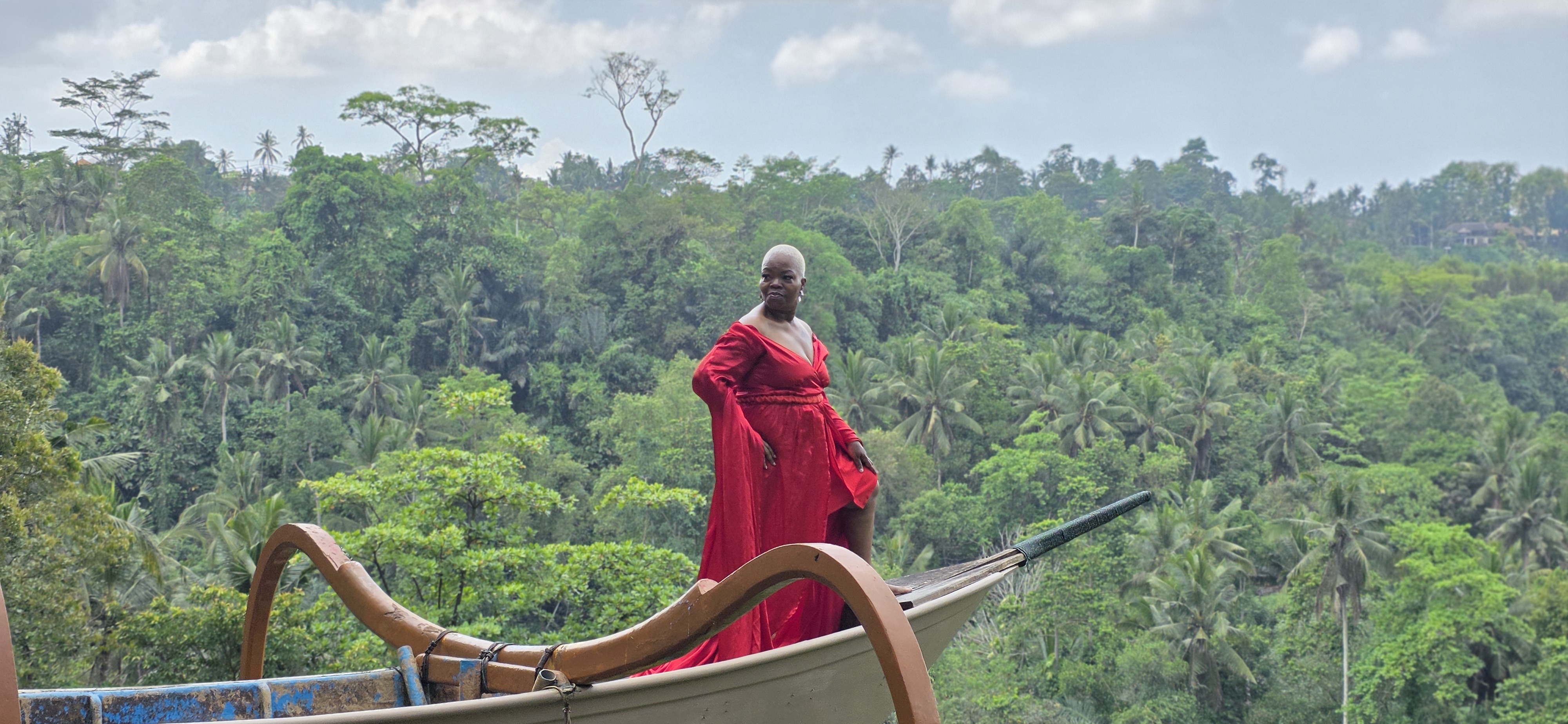 Traveler in a red gown on a Bali boat