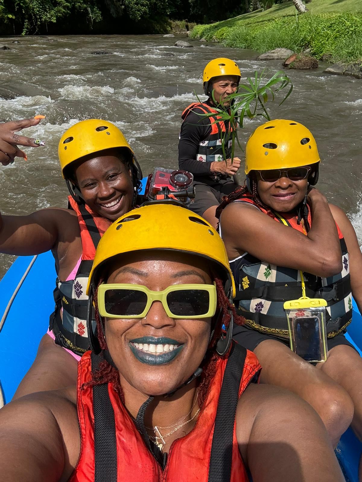 Group of women whitewater rafting in Bali, laughing